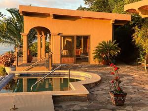 a house with a swimming pool in front of it at The Sanctuary above Lo De Marcos in Lo de Marcos