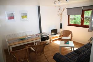 a living room with a couch and a table at Waldkiez Tiefensee in Tiefensee +26 photos