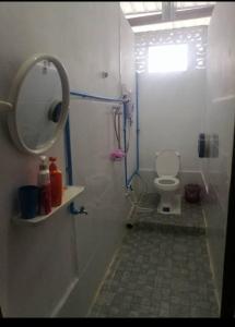 a bathroom with a shower with a toilet and a mirror at Laoshomhotel in Thakhek