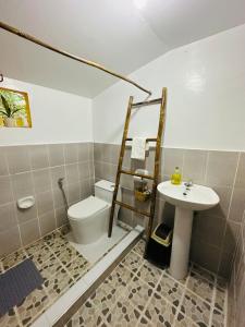 a bathroom with a toilet and a sink at Villa Hortillosa - Your Home Away from Home in Baras +18 photos
