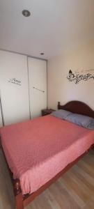 a bedroom with a bed with a red blanket at Casa Duplex AMOBLADO en San Salvador de Jujuy Barrio Las Marias in San Salvador de Jujuy +3 photos