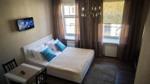 a small room with a bed and a window at Asmera Apartments - Gorokhovaya F2 in Saint Petersburg