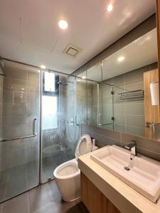 a bathroom with a toilet and a sink and a shower at Chuỗi CHDV the Zei Lê Đức Thọ in Hanoi