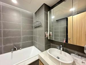 a bathroom with a white tub and a sink at Chuỗi CHDV the Zei Lê Đức Thọ in Hanoi