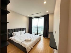 a bedroom with a bed and a large window at Chuỗi CHDV the Zei Lê Đức Thọ in Hanoi