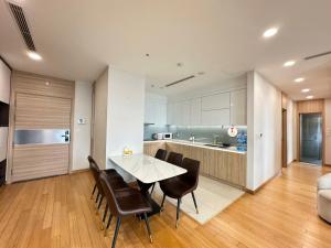 a kitchen and dining room with a table and chairs at Chuỗi CHDV the Zei Lê Đức Thọ in Hanoi +17 photos
