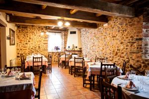 a restaurant with tables and chairs in a room at Hotel Rural El Habanero in Destriana