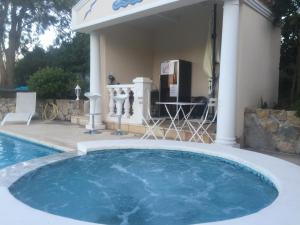 a large swimming pool in a yard next to a house at Villa Manù B&B Chambre D'hote in Les Issambres