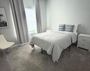 Una habitación blanca con una cama y una ventana en A Getaway on the Gulf Coast, en Gulfport 15 fotos más