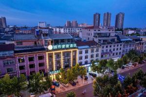 a view of a city at night with buildings at City Comfort Inn Qianjiang Government in Qianjiang