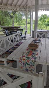 a picnic table with a rug on a patio at Pastoral wooden hauses in Velikiy Les