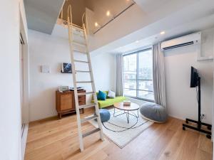 a room with a loft bed and a living room at Mi-HOTEL MIYA SHINJUKU in Tokyo