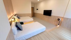 Postel nebo postele na pokoji v ubytování 東港民宿 - 如你所院 Tourist Vacation B&B