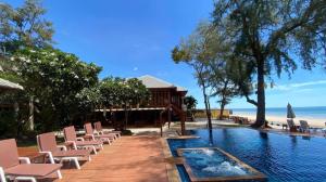 a resort with chairs and a swimming pool at Baan Talay Dao Resort in Hua Hin