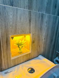 a picture of a vase of flowers on a wall at Royal Vantage in Ella +184 photos