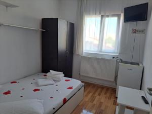 a bedroom with a bed with red roses on it at Vila Emy Constanta in Constanţa