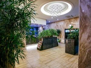 a lobby with potted plants and a chandelier at Hotel Boutique 9 in Seoul
