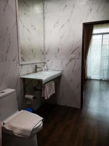 a bathroom with a sink and a toilet at บุญเมืองน่าน in Nan