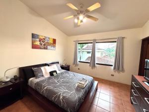 a bedroom with a bed and a ceiling fan at Three Bedroom Spacious Townhome in Coco +34 photos