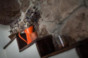 an orange candle in a wooden holder on a wall at Complejo Abiada Rural in Abiada