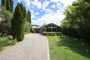 a house with a walkway in front of a yard at On The Trail in Bright