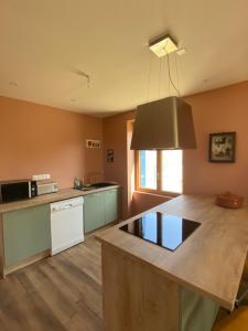 a kitchen with a large island in a room at Parenthèse à la Maison de l'Ecrivain entre nature et petit déjeuner festin in Servon +53 photos