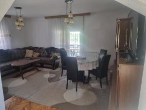 a living room with a table and chairs and a couch at Villa Alejna in Gradačac