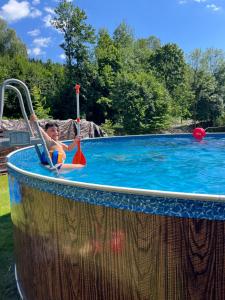 a young child is in a swimming pool at Chata u Cecila in Loučná nad Desnou