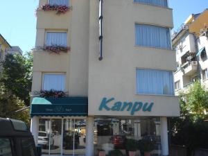 a building with a kpmu sign in front of it at Kapri Hotel in Sofia