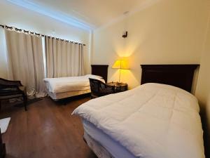 Postel nebo postele na pokoji v ubytování Sri Aurobindo Yoga Mandir