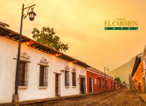a street with a sign on the side of a building at El Carmen Hotel in Antigua Guatemala