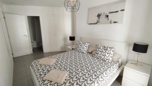 a white bedroom with a bed and a couch at Casa Rincón Medanero in El Médano +20 photos