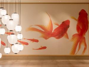 a room with a wall with gold fish and lights at Mitsui Garden Hotel Kyoto Shijo in Kyoto