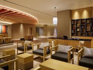 a lobby of a hotel with chairs and a desk at Mitsui Garden Hotel Kyoto Shijo in Kyoto
