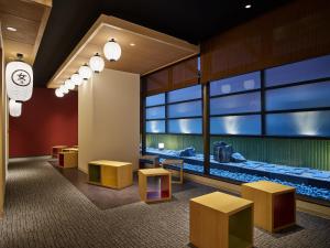 a waiting room with benches and a aquarium at Mitsui Garden Hotel Kyoto Shijo in Kyoto