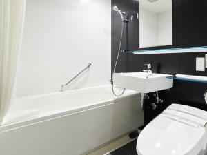 a bathroom with a white toilet and a sink at Mitsui Garden Hotel Kyoto Shijo in Kyoto