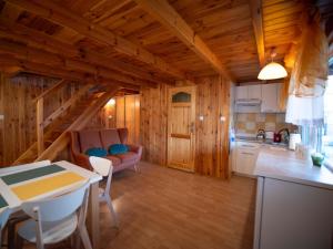 a kitchen and living room in a log cabin at Domek we Władku in Władysławowo