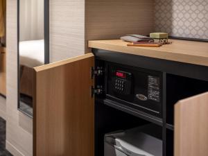 a kitchen with a microwave under a counter at Mitsui Garden Hotel Kyoto Shijo in Kyoto