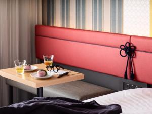 a hotel room with a table with two drinks and glasses at Mitsui Garden Hotel Kyoto Shijo in Kyoto