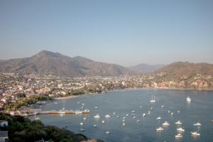 a view of a harbor with boats in the water at Villas El Morro in Zihuatanejo