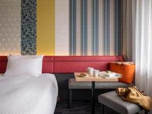 a hotel room with a bed and a table with a tray of food at Mitsui Garden Hotel Kyoto Shijo in Kyoto