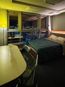 a bedroom with a bed and a table with chairs at Gwangan The L in Busan
