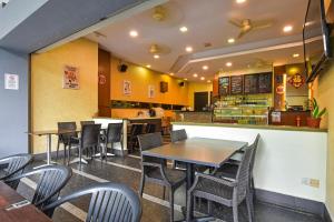 a dining room with tables and chairs in a restaurant at Palette Bukit Bintang Formerly Suasana Suites in Kuala Lumpur