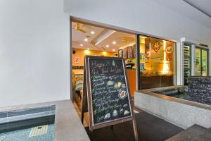 a restaurant with a chalkboard in front of a restaurant at Palette Bukit Bintang Formerly Suasana Suites in Kuala Lumpur