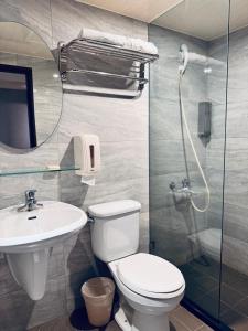 a bathroom with a toilet and a sink and a shower at Tomorrow Hotel in Taipei