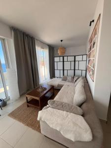 a living room with a couch and a table at Sea View Apartments in Herceg-Novi