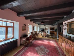 a living room with a red rug on the floor at Feltlův mlýn v Borovnici in Borovnice