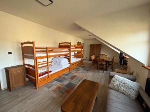 a living room with two bunk beds and a table at Feltlův mlýn v Borovnici in Borovnice +38 photos