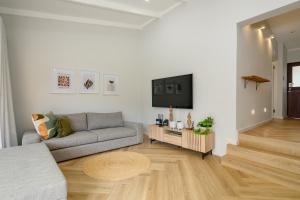 a living room with a couch and a tv at San Lameer Villa 2027 - 2 Bedroom Superior - 4 pax - San Lameer Rental Agency in Southbroom