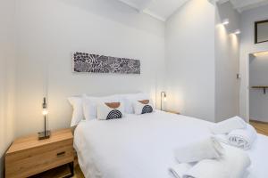 a bedroom with a large bed with white sheets and pillows at San Lameer Villa 2027 - 2 Bedroom Superior - 4 pax - San Lameer Rental Agency in Southbroom +27 photos